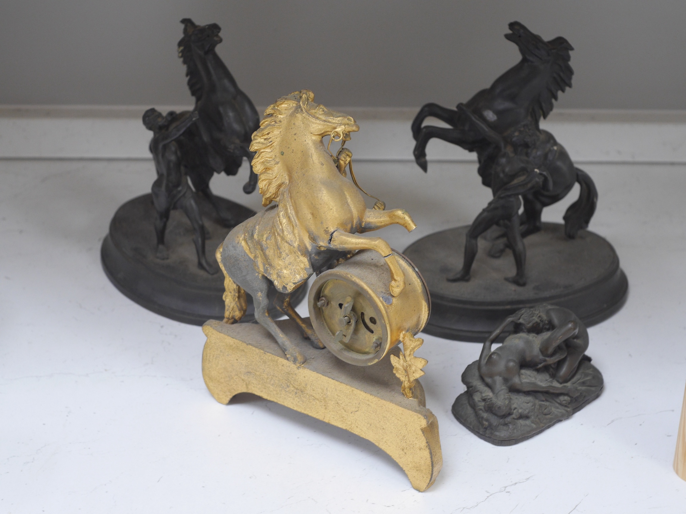 Two Spelter Marley horse groups, a similar timepiece and a bronzed resin erotic figure group after Jef Lambeaux (1852-1908), largest 24cm. Condition - fair